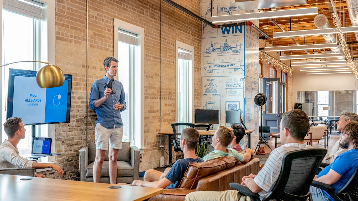 A company team celebrating their build at a hackathon demo